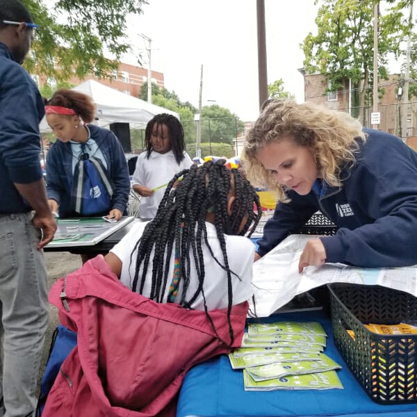Women and a child looking at a map at a Vision Zero event